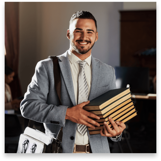 a young man with books on his way to meet with a college advisor